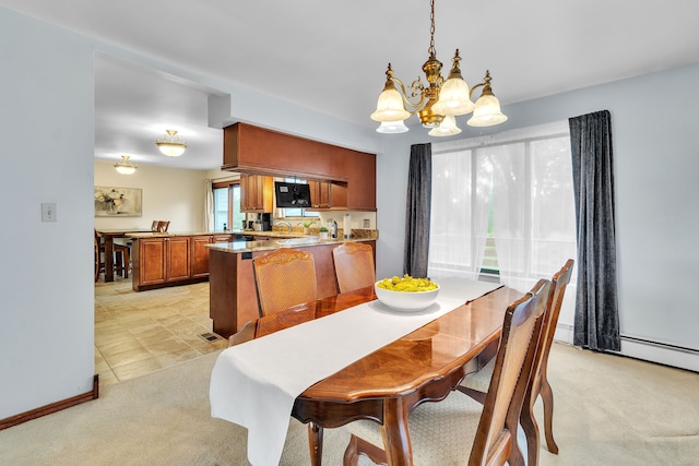 carpeted dining room with sink, a wealth of natural light, and an inviting chandelier