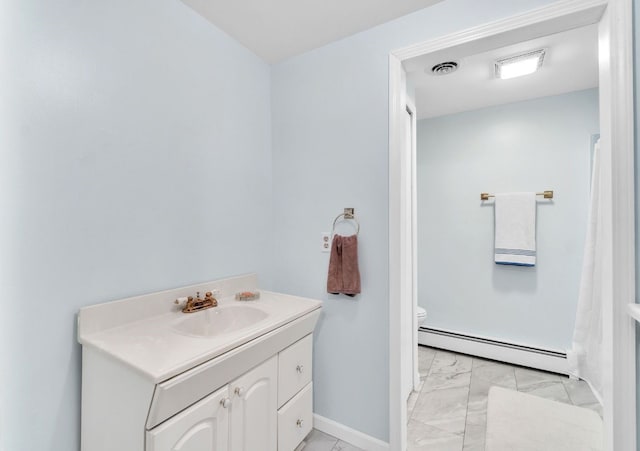 bathroom featuring vanity, toilet, and a baseboard heating unit