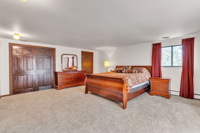 carpeted bedroom with a baseboard radiator