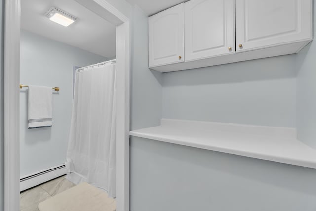 bathroom featuring tile patterned flooring, a baseboard radiator, and a shower with shower curtain