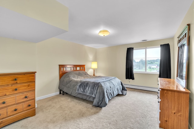 bedroom with light carpet and baseboard heating