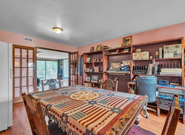 dining space featuring french doors and hardwood / wood-style flooring