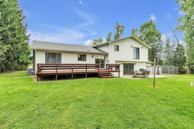 back of property featuring a yard, a patio, and a wooden deck