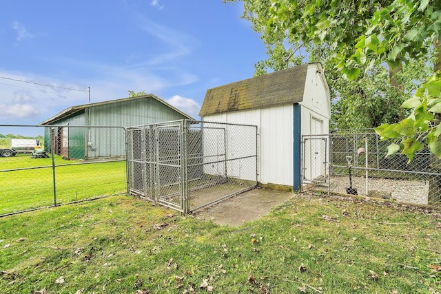 view of outdoor structure featuring a lawn