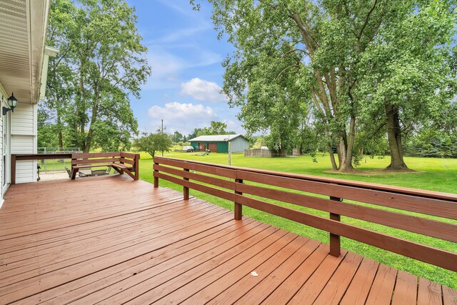 wooden deck featuring a yard