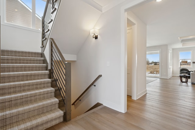 stairs featuring baseboards and wood finished floors