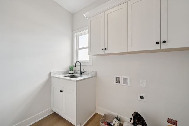 washroom featuring washer hookup, cabinet space, a sink, electric dryer hookup, and baseboards