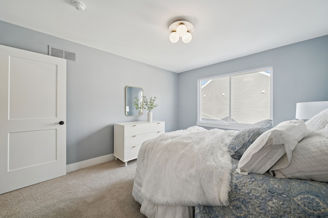 carpeted bedroom with visible vents and baseboards