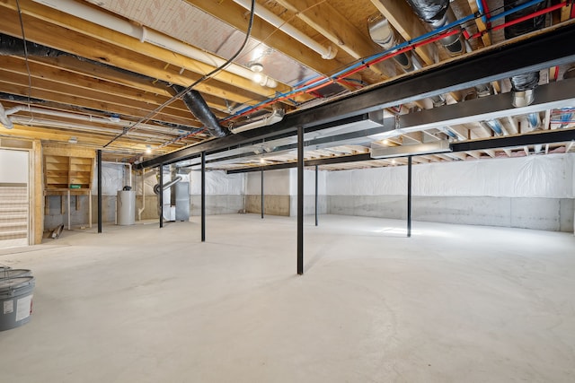 unfinished basement featuring water heater and heating unit