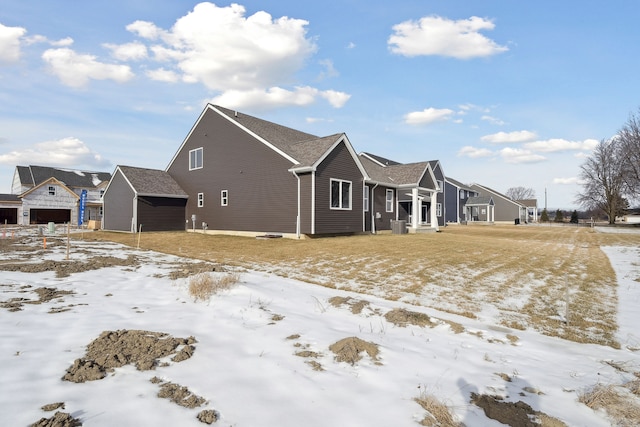 snow covered property with a residential view