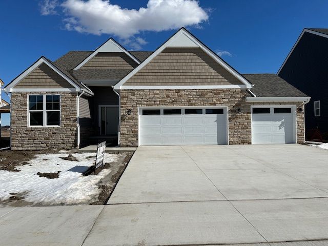 craftsman-style home featuring an attached garage and concrete driveway