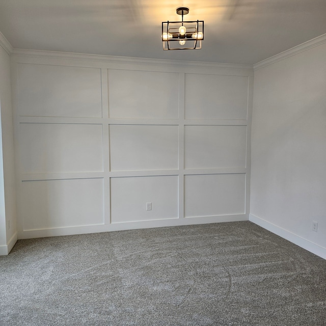 carpeted empty room featuring ornamental molding and a chandelier