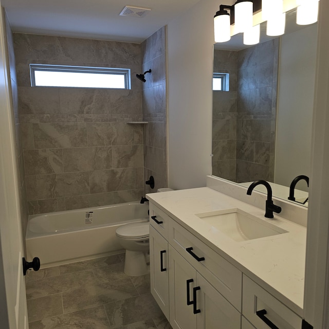 full bathroom featuring vanity, toilet, and tiled shower / bath