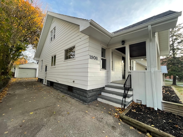 view of property exterior with a garage and an outdoor structure