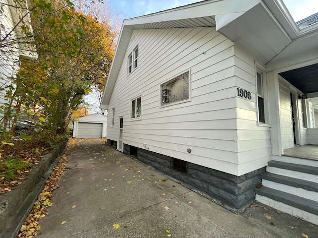 view of home's exterior with an outbuilding and a garage