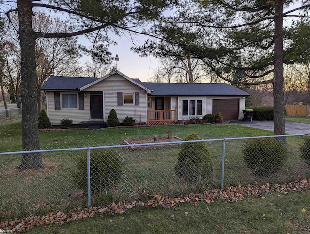 ranch-style house featuring a lawn and a garage