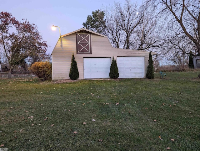 garage at dusk with a yard