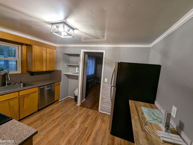 kitchen with black refrigerator, stainless steel dishwasher, ornamental molding, sink, and light hardwood / wood-style flooring