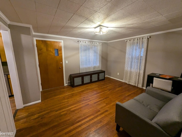 sitting room featuring crown molding and dark wood-type flooring