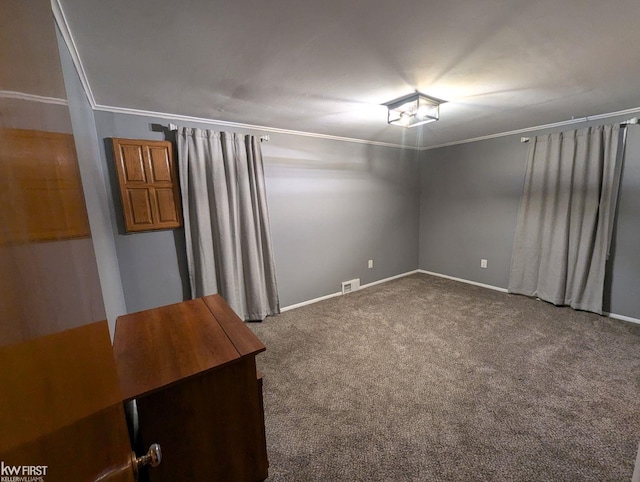 carpeted empty room featuring crown molding