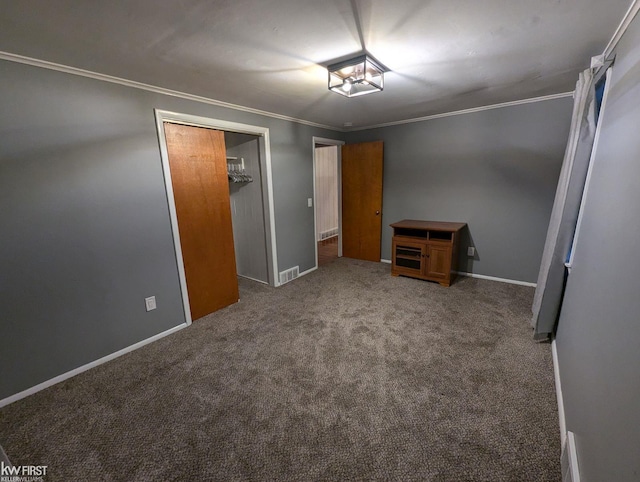 unfurnished bedroom featuring crown molding, a closet, and carpet