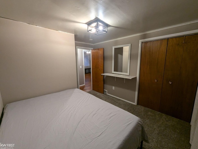 carpeted bedroom featuring a closet and ornamental molding