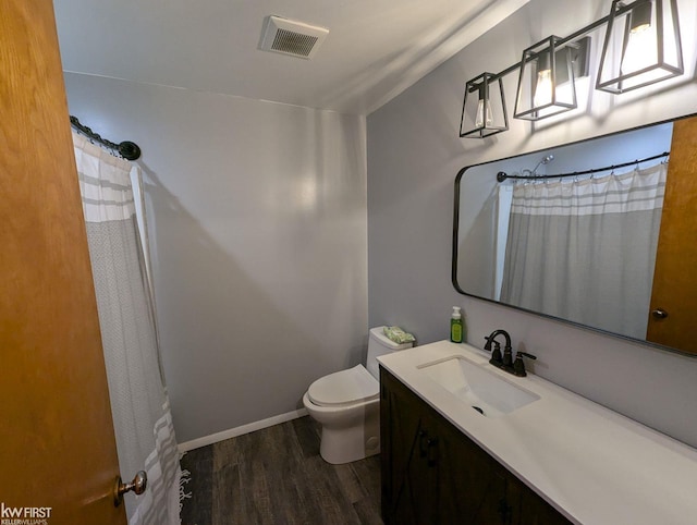 bathroom featuring hardwood / wood-style floors, vanity, toilet, and lofted ceiling