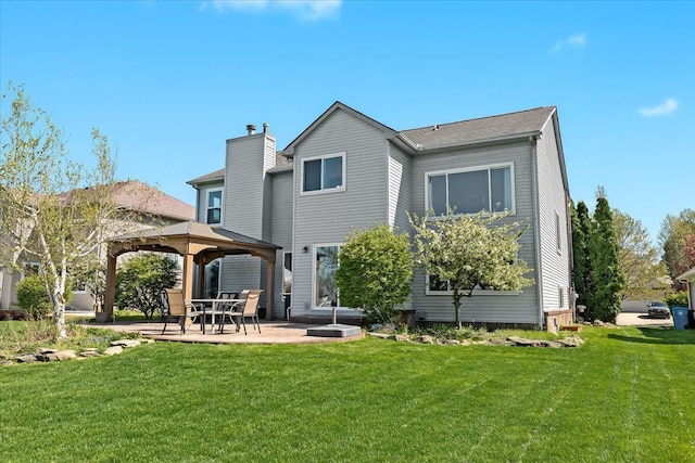 back of house featuring a gazebo, a patio area, and a lawn