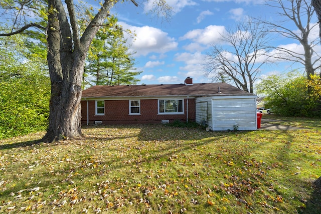 rear view of house featuring a lawn