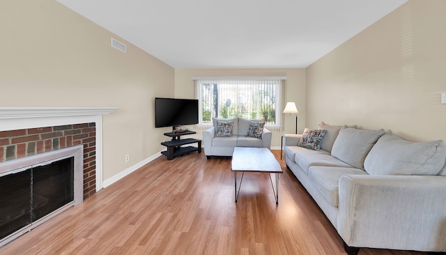 living room featuring a fireplace and wood-type flooring