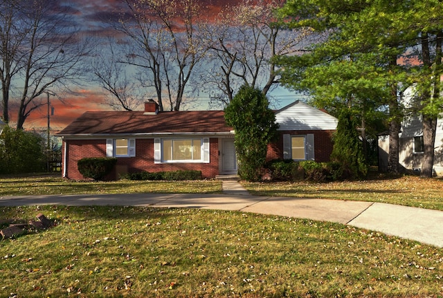 ranch-style home with a lawn