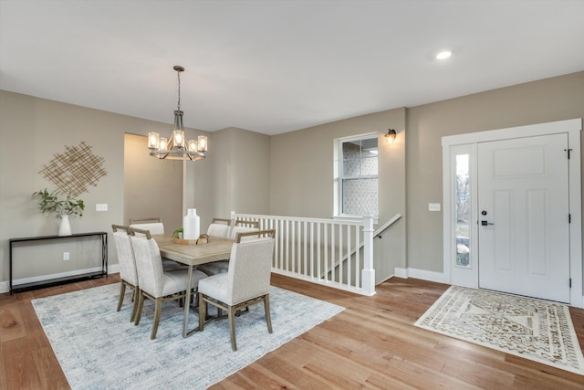 dining area featuring light hardwood / wood-style flooring and an inviting chandelier