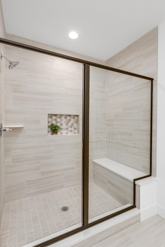 bathroom with tile patterned flooring and a shower with shower door