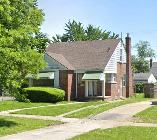 bungalow-style home with a front yard