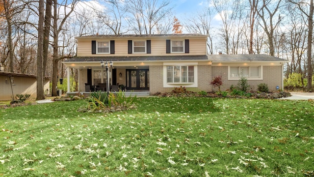 view of property featuring a front lawn and covered porch