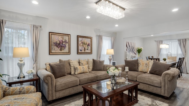 living room featuring a notable chandelier and dark hardwood / wood-style flooring