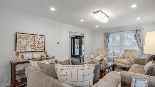 living room with hardwood / wood-style flooring and a notable chandelier