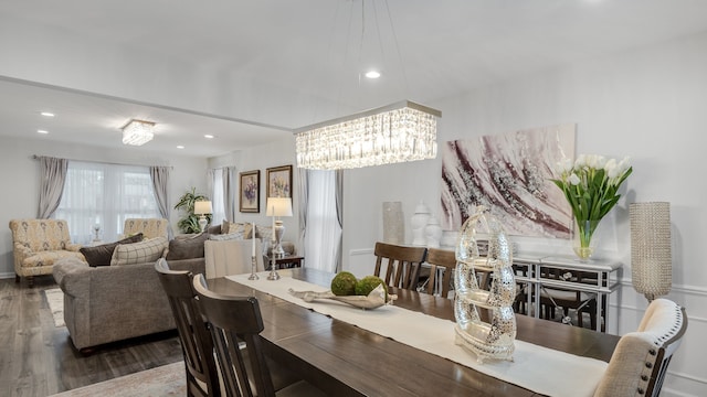 dining area with hardwood / wood-style floors and a chandelier