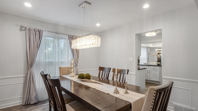 dining area with dark hardwood / wood-style flooring and a chandelier