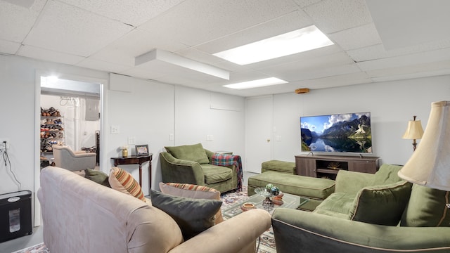 living room featuring a paneled ceiling