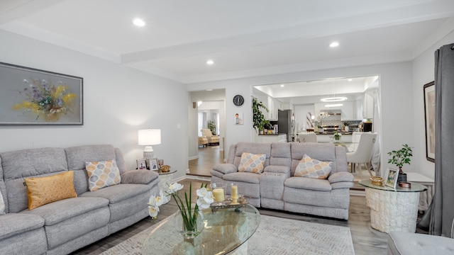 living room featuring beam ceiling and light hardwood / wood-style flooring