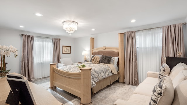 bedroom featuring light wood-type flooring and a notable chandelier