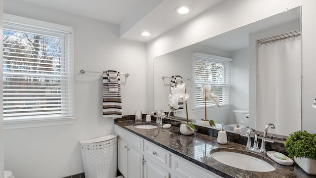 bathroom featuring vanity and toilet