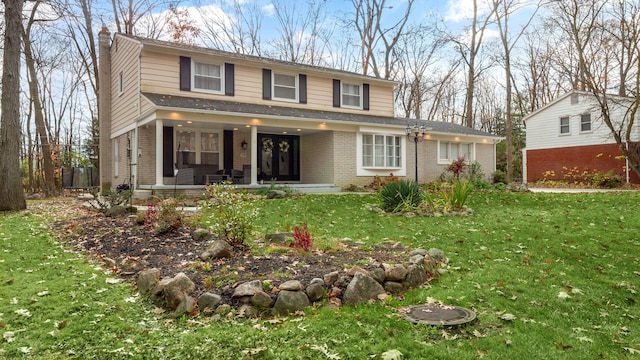 view of front of property with a front yard and covered porch