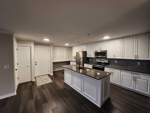 kitchen featuring tasteful backsplash, dark hardwood / wood-style flooring, white cabinets, and appliances with stainless steel finishes