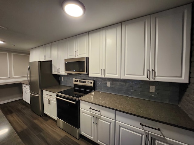 kitchen featuring tasteful backsplash, dark wood-type flooring, white cabinets, and stainless steel appliances