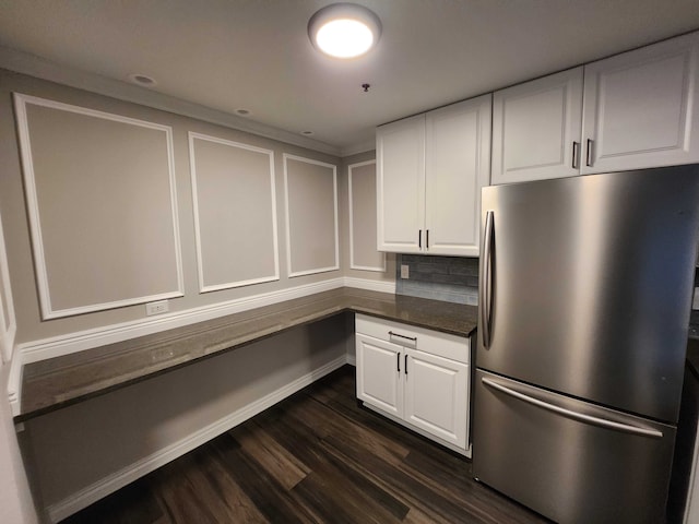 kitchen with decorative backsplash, stainless steel fridge, white cabinets, and dark wood-type flooring