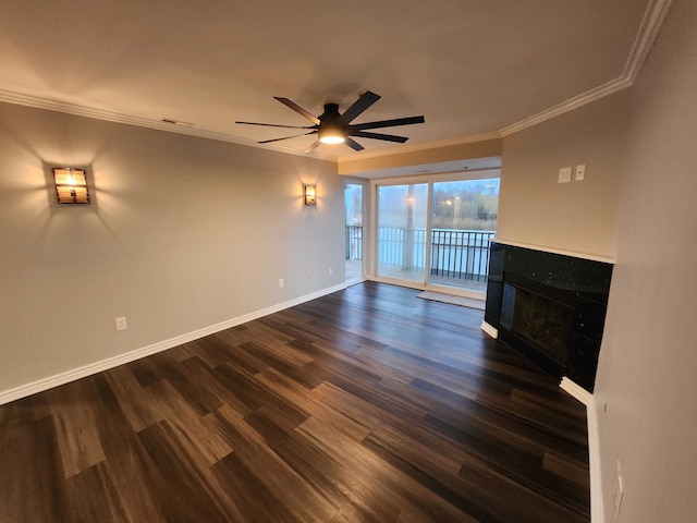 unfurnished living room featuring ceiling fan, dark hardwood / wood-style flooring, and ornamental molding