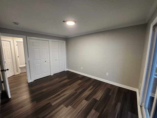 unfurnished bedroom featuring a closet and dark wood-type flooring