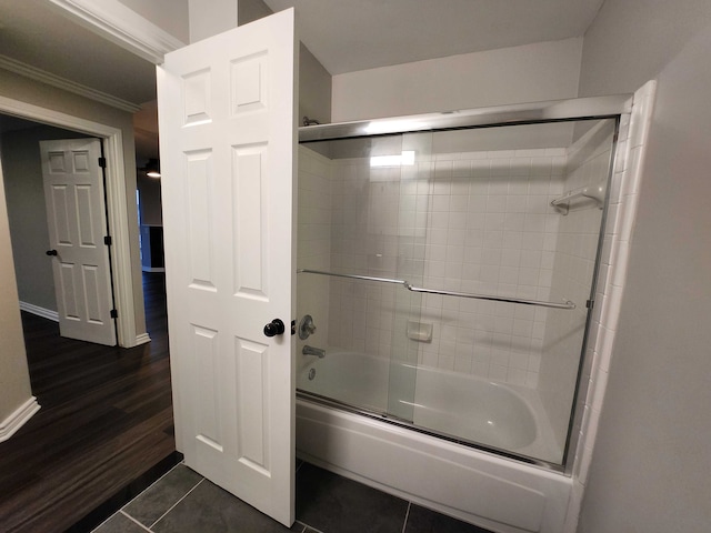 bathroom featuring shower / bath combination with glass door, tile patterned floors, and ornamental molding